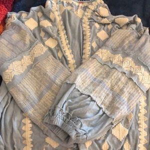 Blue top, one button, white embroidered